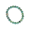Green beaded bracelet with a silver charm on a clear background